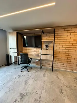 an empty office with a chair and a desk at Apartaestudio in Medellín