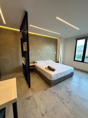 a bedroom with a bed and a large window at Apartaestudio in Medellín