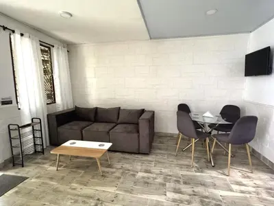 a living room with a couch and chairs and a table at Casa Alba, El Poblado in Medellín