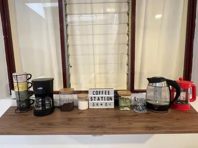 a counter with coffee stations on a window sill at Casa Alba, El Poblado in Medellín