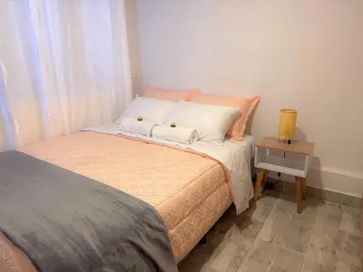 a bedroom with a bed with two pillows on it at Casa Alba, El Poblado in Medellín