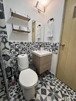 a bathroom with a toilet and a sink at Casa Alba, El Poblado in Medellín