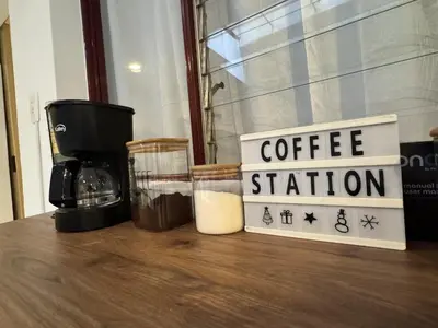 a coffee station sign on a table with a coffee maker at Casa Alba, El Poblado in Medellín