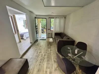 a living room with a table and a couch at Casa Alba, El Poblado in Medellín