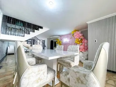 a dining room with a table and chairs and balloons at Private pool and Jacuzzi rentals in Medellin - VIC in Medellín