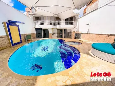 a large swimming pool in the middle of a building at Private pool and Jacuzzi rentals in Medellin - VIC in Medellín