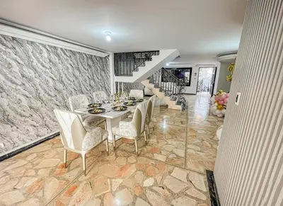 a dining room with a table and chairs and a staircase at Private pool and Jacuzzi rentals in Medellin - VIC in Medellín