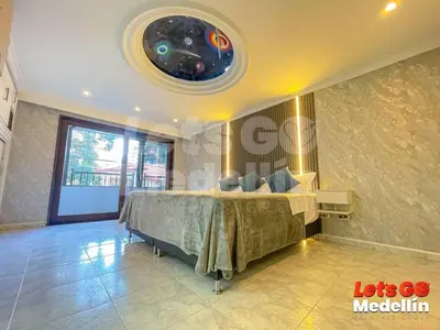 a bedroom with a large bed in a room at Private pool and Jacuzzi rentals in Medellin - VIC in Medellín