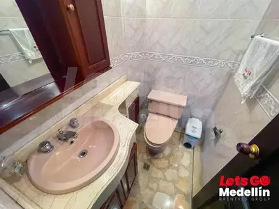 a bathroom with a sink and a toilet at Private pool and Jacuzzi rentals in Medellin - VIC in Medellín
