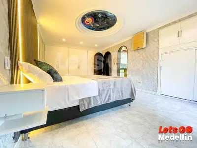 a bedroom with a large bed in a room at Private pool and Jacuzzi rentals in Medellin - VIC in Medellín