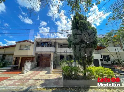 a house with a tree in front of it at Private pool and Jacuzzi rentals in Medellin - VIC in Medellín