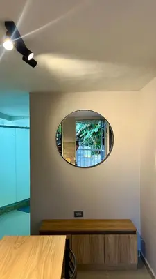 a room with a circular mirror on the wall at Ideal apartment, view, park and key location in Medellín
