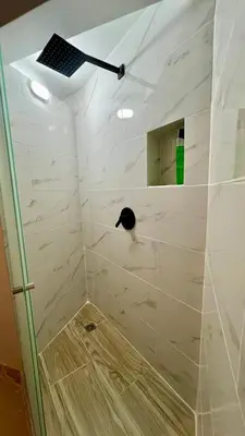 a bathroom with a shower with a cat in it at Ideal apartment, view, park and key location in Medellín