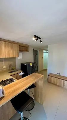 a kitchen with a desk and a counter top at Ideal apartment, view, park and key location in Medellín