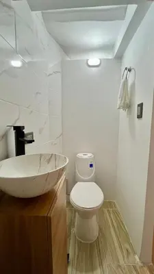 a bathroom with a bowl sink and a toilet at Ideal apartment, view, park and key location in Medellín