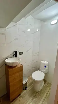 a bathroom with a toilet and a sink at Ideal apartment, view, park and key location in Medellín