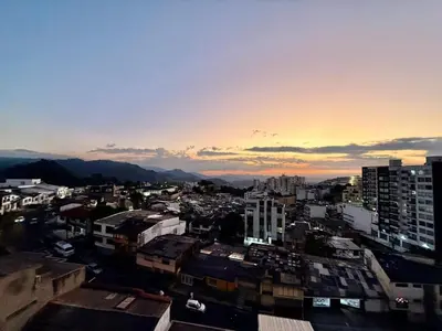 a view of a city at sunset with buildings at Estrena Apartamento, Avenida Santander, BREAK SUITES in Manizales