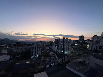 a view of a city skyline at sunset at Estrena Apartamento, Avenida Santander, BREAK SUITES in Manizales