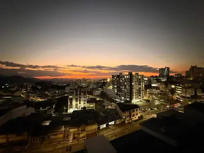 a city skyline at night with the sun setting at Estrena Apartamento, Avenida Santander, BREAK SUITES in Manizales