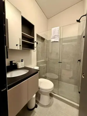 a bathroom with a toilet and a sink and a shower at Estrena Apartamento, Avenida Santander, BREAK SUITES in Manizales