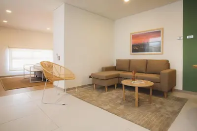 a living room with a couch and a table at NOK Splendid studio in Laureles Medellin in Medellín