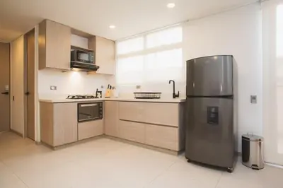 a kitchen with a stainless steel refrigerator in it at NOK Splendid studio in Laureles Medellin in Medellín