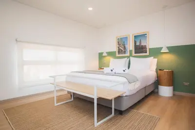 a bedroom with a large bed and a table at NOK Splendid studio in Laureles Medellin in Medellín