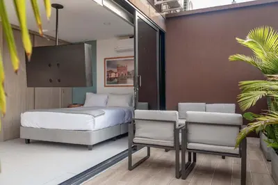a bedroom with a bed and a table and chairs at NOK Perfect 1BR in Laureles Medellin in Medellín
