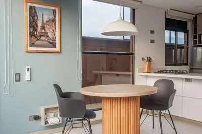 a kitchen with a wooden table and chairs at NOK Perfect 1BR in Laureles Medellin in Medellín