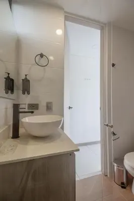 a bathroom with a white bowl sink on a counter at NOK Perfect 1BR in Laureles Medellin in Medellín
