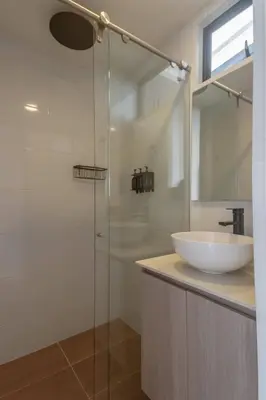 a bathroom with a sink and a glass shower at NOK Perfect 1BR in Laureles Medellin in Medellín