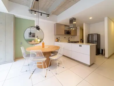a kitchen with a wooden table and chairs at NOK Panoramic 3 BR in Laureles Medellin in Medellín