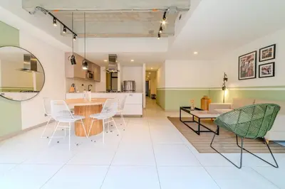 a kitchen and dining room with a table and chairs at NOK Panoramic 3 BR in Laureles Medellin in Medellín