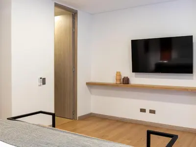 a room with a flat screen tv on a wall at NOK Panoramic 3 BR with terrace in Laureles Medellin in Medellín