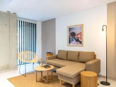 a living room with a couch and a table at NOK Panoramic 3 BR with terrace in Laureles Medellin in Medellín