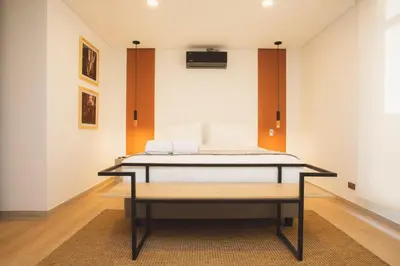 a bed in the middle of a room at NOK Cozy 3 BR in Laureles in Medellin in Medellín