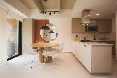 a kitchen with a table and chairs and a mirror at NOK Cozy 3 BR in Laureles in Medellin in Medellín
