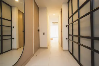 a hallway with a mirror on the wall and a door at NOK Cozy 3 BR in Laureles in Medellin in Medellín