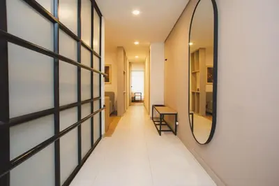 a hallway with a mirror on a wall at NOK Cozy 3 BR in Laureles in Medellin in Medellín