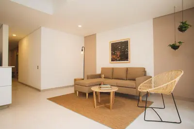 a living room with a couch and a table and chairs at NOK Cozy 3 BR in Laureles in Medellin in Medellín