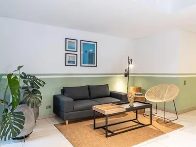 a living room with a couch and a table at NOK Cozy 3 BR with Balcony in Laureles Medellin in Medellín