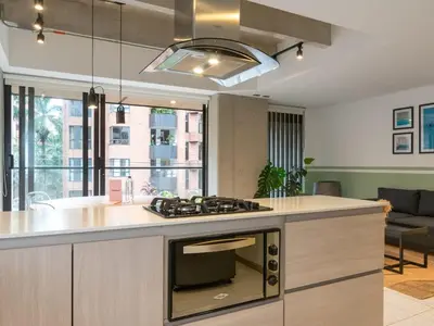 a kitchen with a stove top oven in a room at NOK Cozy 3 BR with Balcony in Laureles Medellin in Medellín