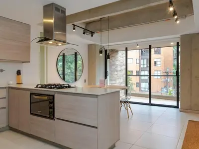 a kitchen with a stove and a counter top at NOK Cozy 3 BR with Balcony in Laureles Medellin in Medellín