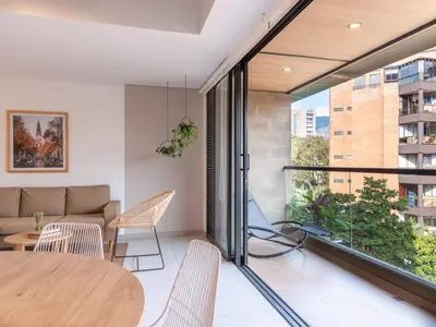 a living room with a table and chairs and a couch at NOK Perfect 3 BR with Balcony in Laureles Medellin in Medellín