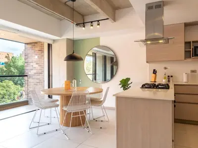 a kitchen with a table and chairs and a window at NOK Perfect 3 BR with Balcony in Laureles Medellin in Medellín