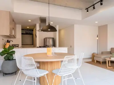 a kitchen and dining room with a wooden table and chairs at NOK Perfect 3 BR with Balcony in Laureles Medellin in Medellín