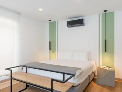 a bedroom with a bed and a bench in it at NOK Fantastic 3 BR w Balcony in Laureles Medellin in Medellín