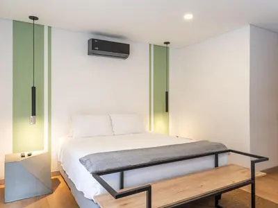 a bedroom with a bed with a bench next to it at NOK Fantastic 3 BR w Balcony in Laureles Medellin in Medellín