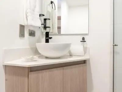 a bathroom with a white sink and a mirror at NOK Fantastic 3 BR w Balcony in Laureles Medellin in Medellín
