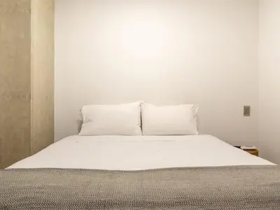 a white bed with two pillows on top of it at NOK Fancy 3BR Balcony in Laureles Medellin in Medellín